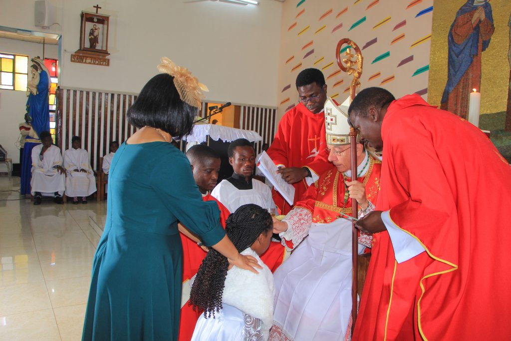 The Nuncio administering sacrament of confirmation