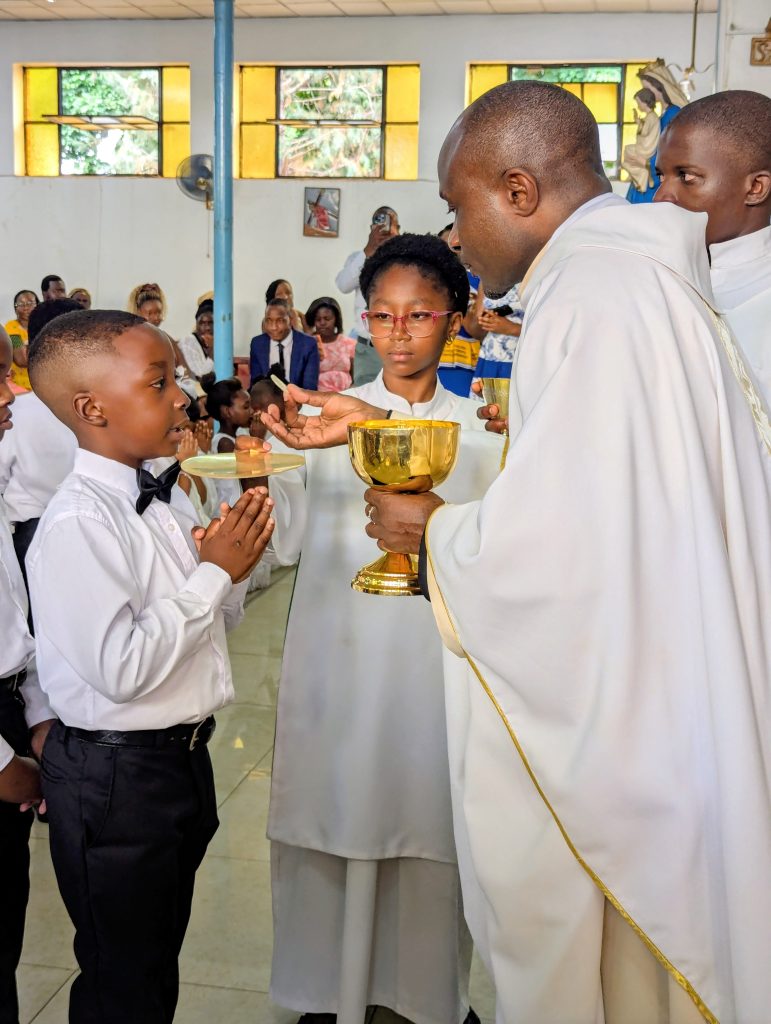 A child receives the Body of Christ for the very first time on the Second Sunday of Advent. May their faith grow strong!