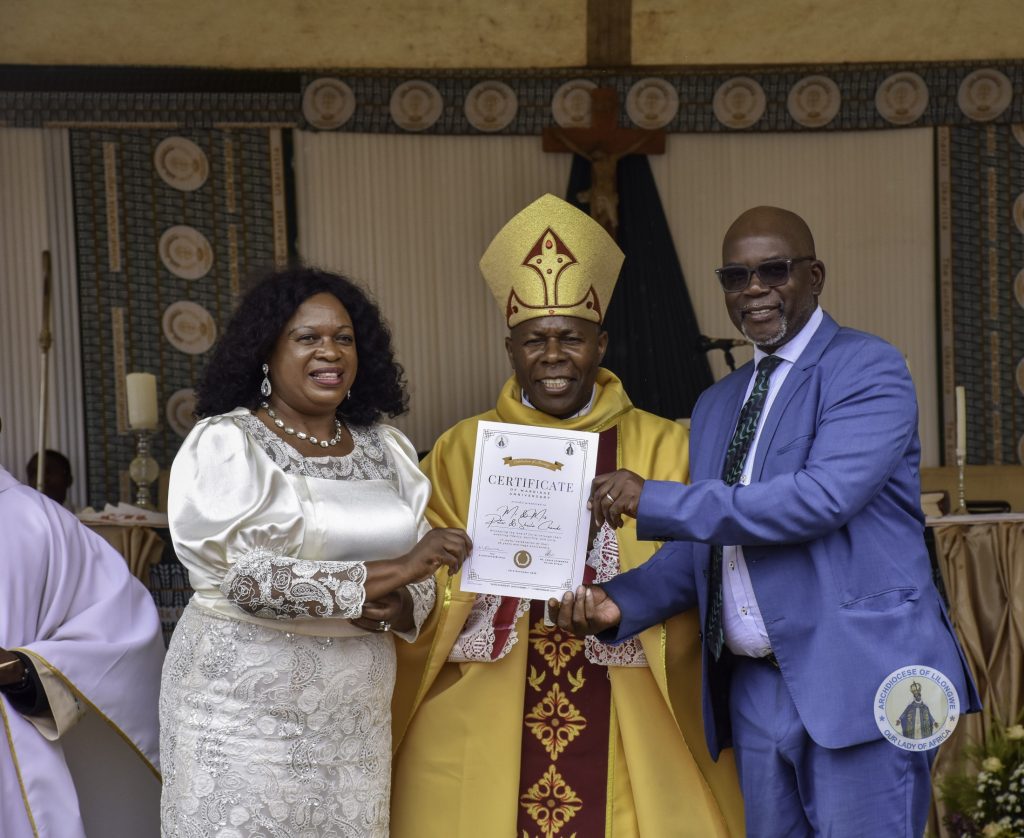 The Family of Mr. and Mrs. Chando from Maula’s St. Francis SCC, showing their Certificate of recognition for 35 years in married life