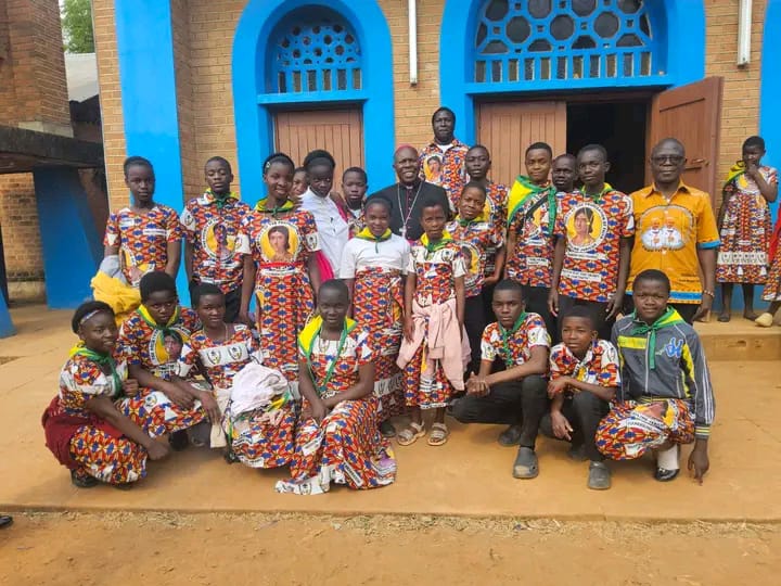 Maula Parish Children and teachers pose with the Auxiliary Bishop of Lilongwe, His Lordship Vincent Mwakhwawa